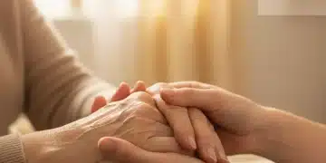 2026 Government Programs: Up to $1,200 for Elderly Caregiver Support Close-up of a caregiver's hand holding an elderly person's hand, representing support and care for seniors.