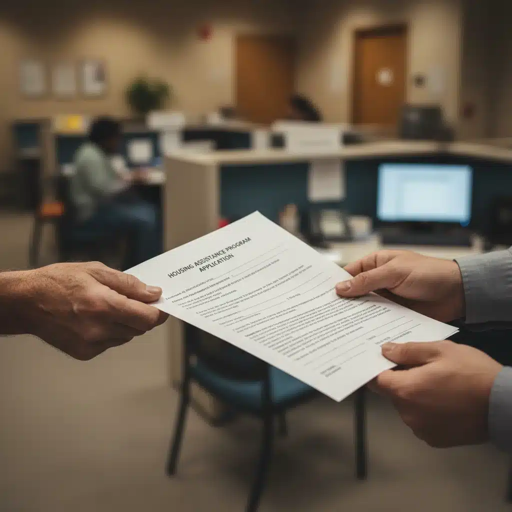Hands exchanging housing assistance application documents in an office setting.